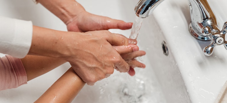 two people washing their hands