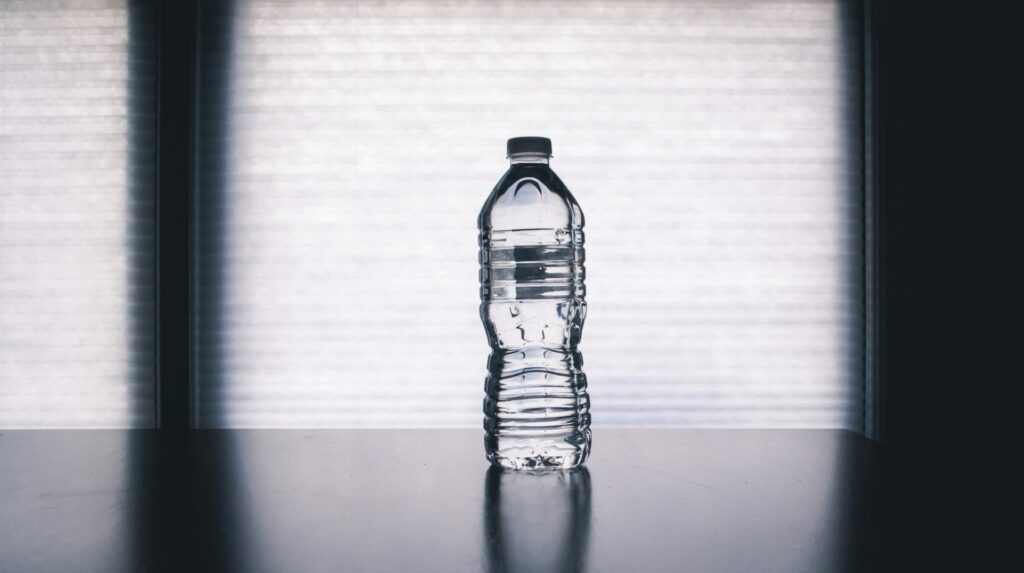 A single water bottle on a desk